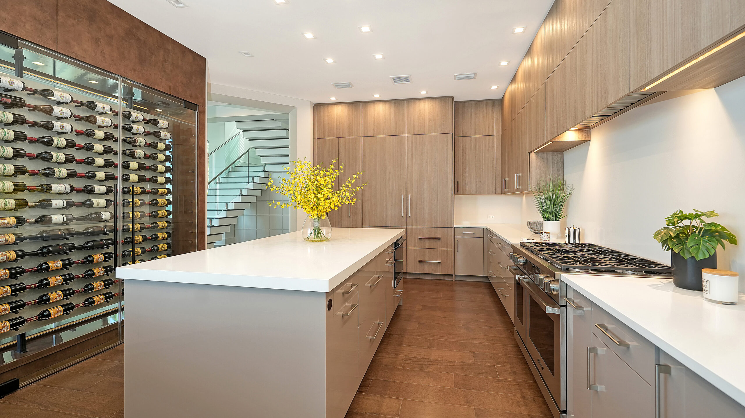 Metro Cabinet Company galley kitchen with a wine wall, island, and full-height cabinet bank